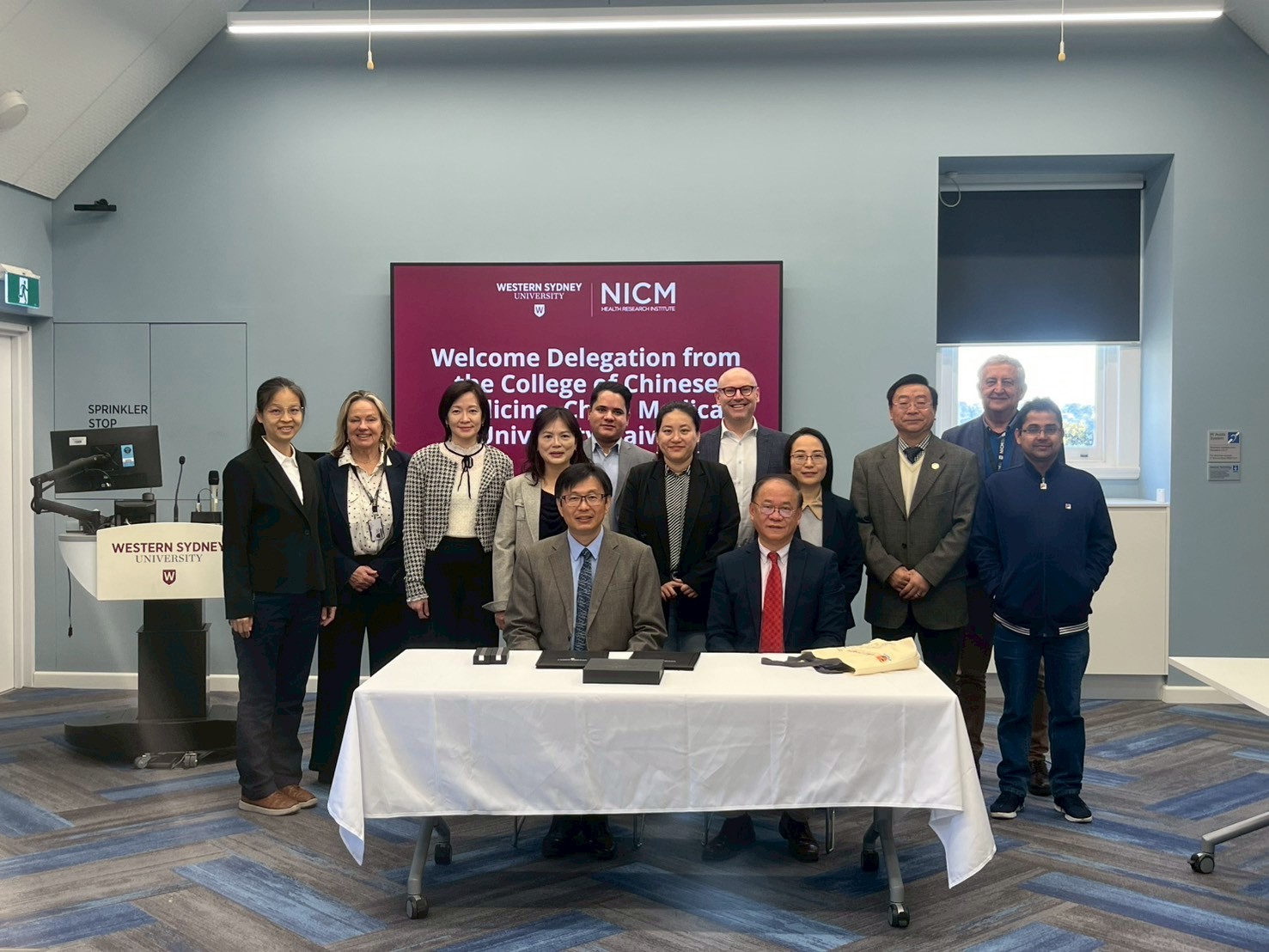 Figure 3: Photo of speakers at the "NICM–CMU Joint Symposium: Advancing Evidence-based Chinese Medicine Research and Practice."